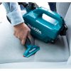 MAKITA Kalustesuulake, vihreä 120 mm. Kuvassa henkilö imuroimassa autotekstiilejä.