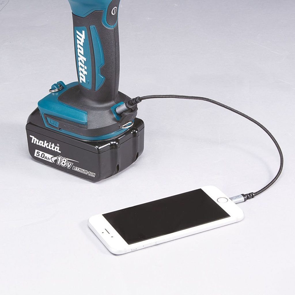 MAKITA LED-valaisin LXT. Lähikuvassa LED-valaisin LXT yhdistettynä matkapuhelimeen USB-kaapelin avulla.