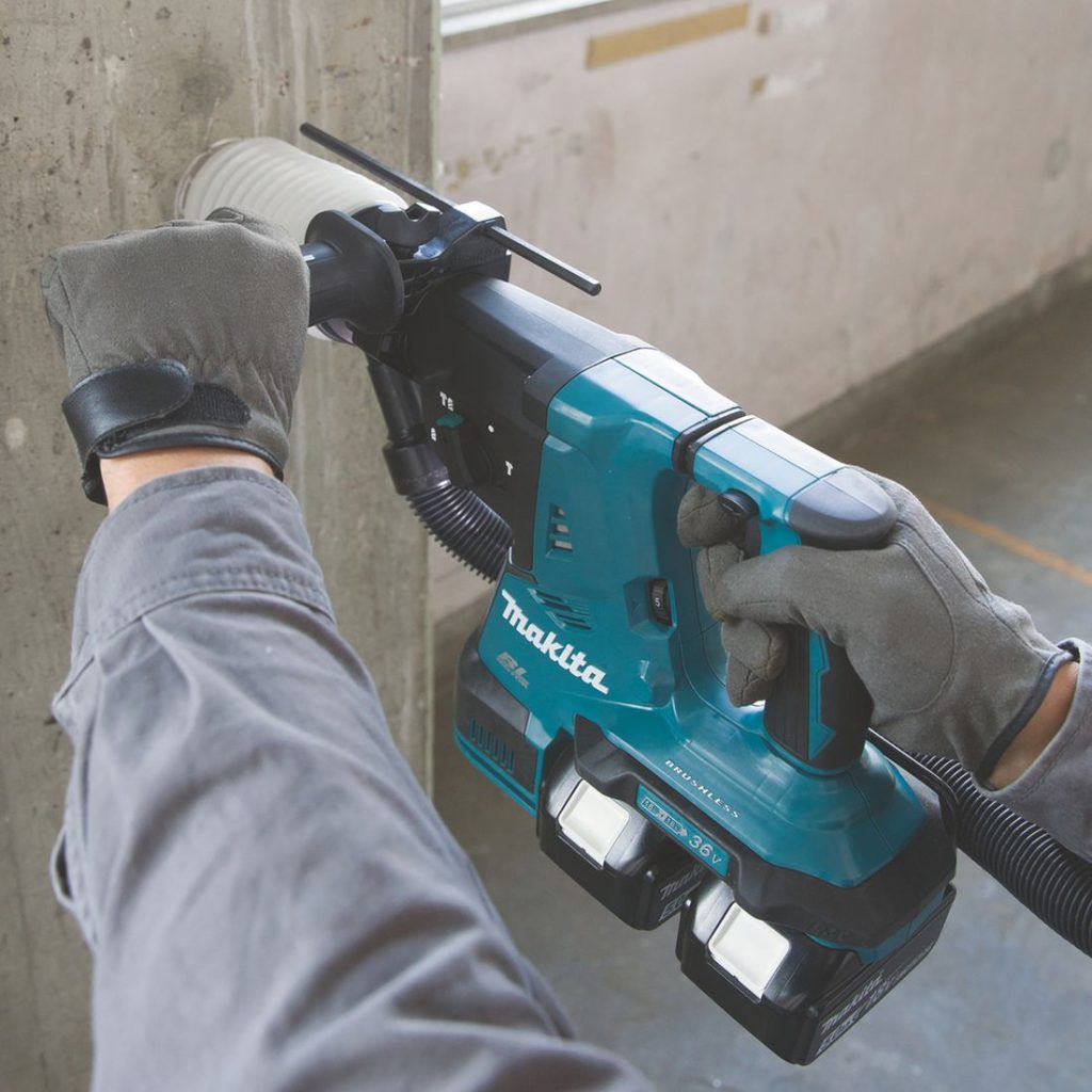 MAKITA Poravasara LXT. Kuvassa henkilö poraamassa reikää betoniseinään Poravasara LXT:n avulla.
