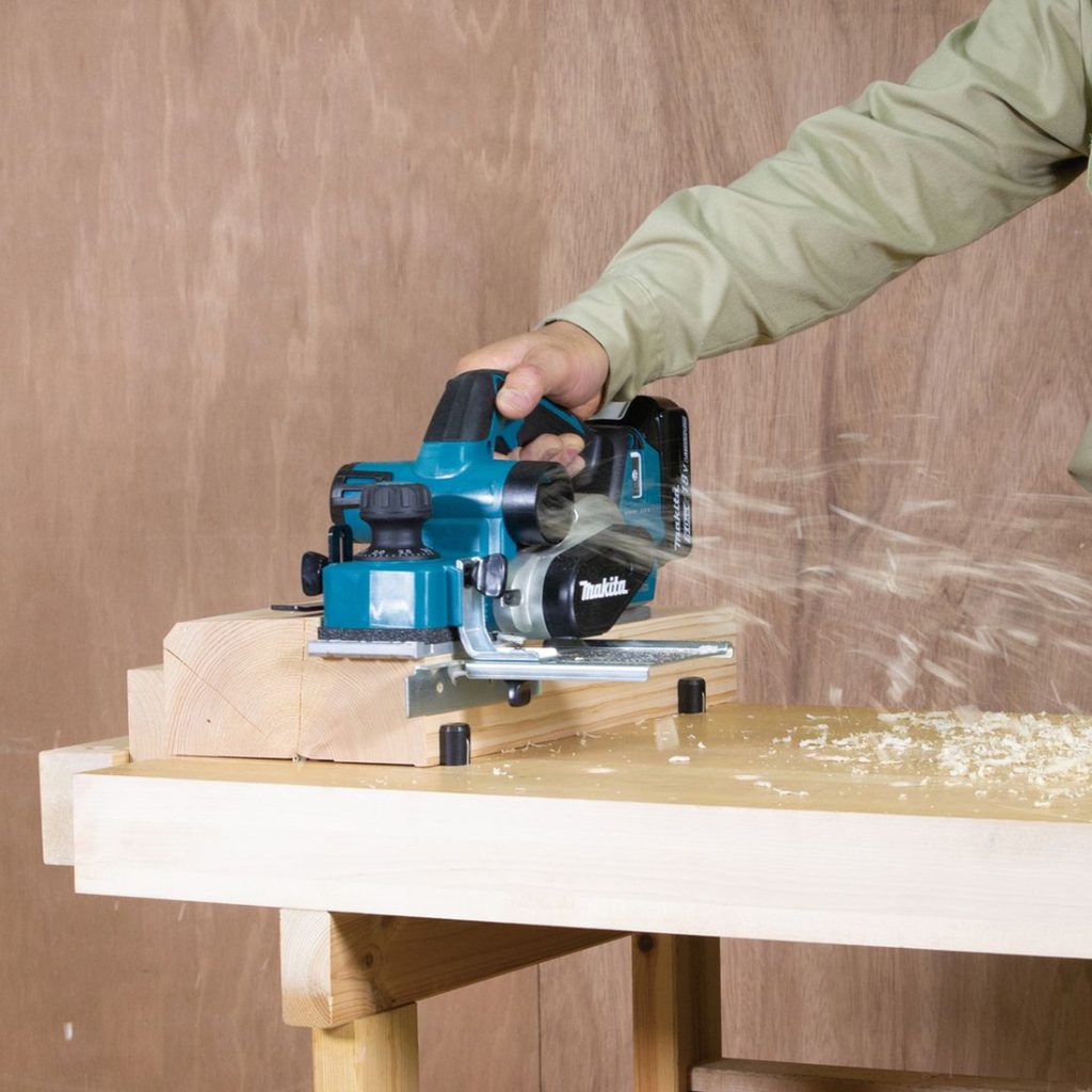 MAKITA Höylä LXT. Kuvassa henkilö höyläämässä paksua palkkia höylä LXT:n avulla.