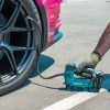 MAKITA Ilmapumppu LXT. Kuvassa henkilö täyttämässä auton rengasta Ilmapumppu LXT: avulla.